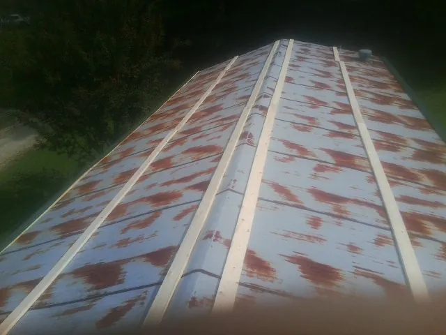 Rusted metal roof panels with new wood purlins before replacement — Storm Damage Roof Repair in Lima by Roofing Brothers